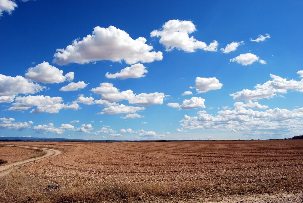 field, land, clouds, sky, horizon, agriculture, plowing, cloudy, arid, dry, cumulus, blue sky, rural, nature, countryside